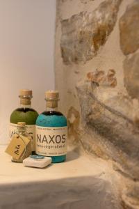 two bottles of alcohol sitting on a shelf next to a rock at Naxos Boutique Suites Luxury Minimalism in Filoti in Philotium +31 photos