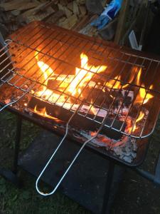 a grill that is cooking on top of a grill at Gites Libellule at Auberge de l'Arac, Bar, Restaurant in Aleu