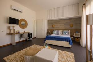 a bedroom with a bed and a table and a couch at Villa Olimpia in Mondello