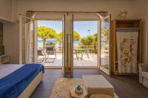 a bedroom with a bed and a view of the ocean at Villa Olimpia in Mondello
