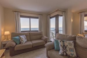a living room with a couch and views of the ocean at Apartamento con increibles vistas al mar in Can Picafort