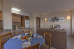 a kitchen with a table with a bowl of fruit on it at Apartamento con increibles vistas al mar in Can Picafort +9 photos