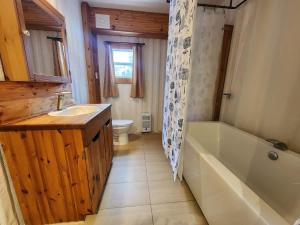 a bathroom with a tub and a sink and a toilet at La Maison Conteneur in Amos +76 photos
