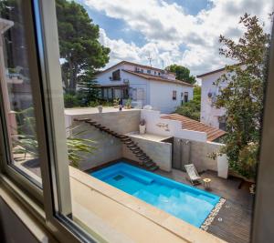 a view of a swimming pool from a window at Villa Olimpia in Mondello