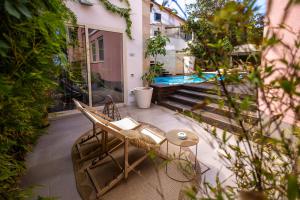 a patio with a table with a laptop on it at Villa Olimpia in Mondello