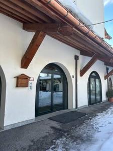 a building with arched doors and a wooden roof at TORRE OROLOGIO Direttamente sulle piste in Sestriere +17 photos
