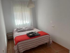 a small bedroom with a bed with a red blanket at Balcón de la Torre del Morche en Torrox Costa in El Morche +16 photos