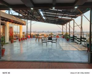 a patio with tables and chairs on a roof at hotel Elites Residency , iqbal town in Lahore