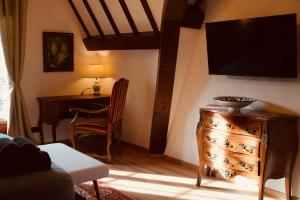 a living room with a desk and a tv on the wall at Normandy Etretat in Étretat