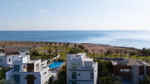 an aerial view of houses and the ocean at Vivo Mare Beachfront Villas - Seashell in Ayia Napa
