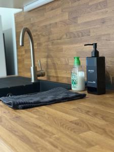 a kitchen counter with a sink and a bottle of soap at Le Commerce-Gare-Centre-Ville in Montbéliard