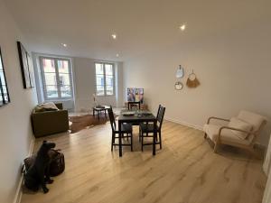a living room with a table and chairs at Le Commerce-Gare-Centre-Ville in Montbéliard +16 photos