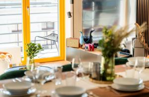 a table with plates and glasses and a window at Wenceslas sq SOHO Boutique Hotel & Premium Suites in Prague +36 photos