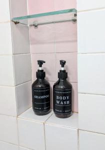 two bottles of soap sitting on a shelf in a bathroom at Villa Fabiani in Fonte Nuova +22 photos