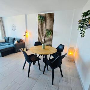 a living room with a wooden table and chairs at Marbella city center appartment walking distance beach and plaza de los naranjos in Marbella