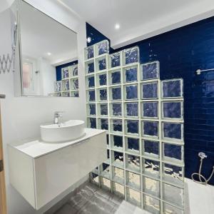 a bathroom with a sink and a blue tile wall at Marbella city center appartment walking distance beach and plaza de los naranjos in Marbella