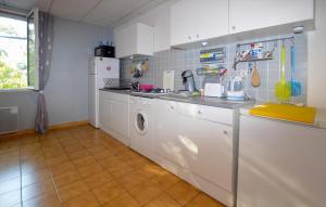 a kitchen with white cabinets and a washer and dryer at Lovely Home In San Gavino Di Fiumorbo in San-Gavino-di-Fiumorbo