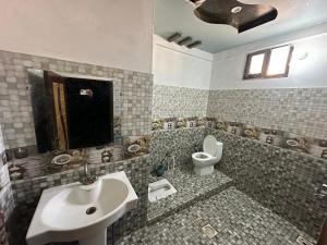 a bathroom with a sink and a toilet at Hotel Serena in Hyderabad