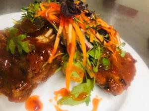 a white plate topped with food with carrots and lettuce at The Halfway House Pub and Kitchen in Saint Germans