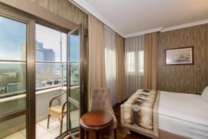 a hotel room with a bed and a balcony at Crestium Taksim Prive & Spa in Istanbul +15 photos