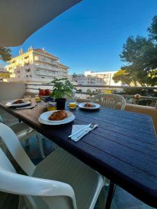 a table with plates of food on a balcony at 2 Bedroom Apartment in Puerto Marina in Benalmadena Costa