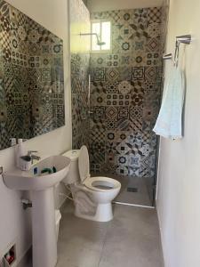 a bathroom with a toilet and a sink and a shower at Casa Sofia in Taganga +14 photos