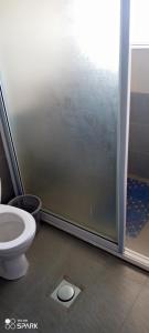 a bathroom with a toilet and a shower stall at staroot residence in Nairobi