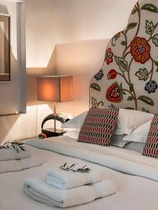 a bedroom with a bed with towels on it at Garden Suites in Corfu +42 photos