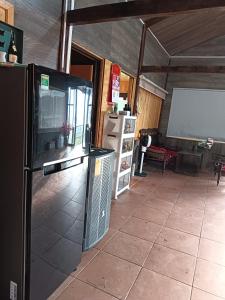 a living room with a refrigerator and a screen at Chalet Bungalow Kala by Tâm Miên Man Homestay in Di Linh +10 photos