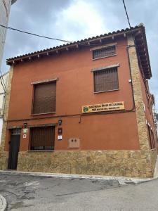 un edificio di mattoni marroni con un cartello sopra di Casa Rural Hoces del Cabriel a Villargordo del Cabriel