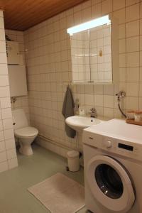 a bathroom with a washing machine and a sink at Two-room apartment in the center of Helsinki with a sauna! Free parking! in Helsinki +11 photos
