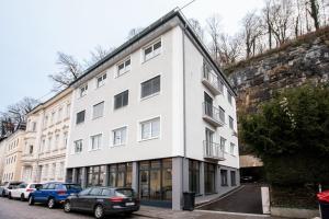 a white building with cars parked in front of it at Magazin Rooms in Salzburg