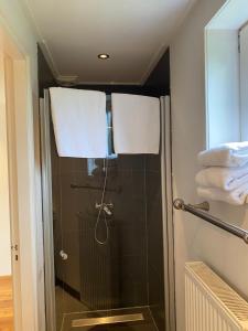 a bathroom with a shower with two towels at B&B de Tol in Hulst +76 photos