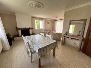 a living room with a table and a couch at Les Saules in Saint-Gilles-Croix-de-Vie