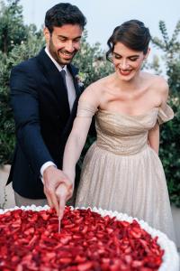a bride and groom cutting their wedding cake at La Fiermontina Palazzo Bozzi Corso Hotel in Lecce +184 photos