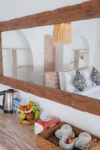 a kitchen counter with a shelf with food on it at Bunbulan sunshine in Kubupenlokan +36 photos