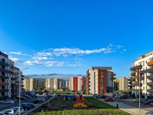 a parking lot with a playground in a city at Alegria Avantgarden Brasov in Braşov