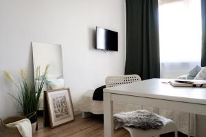 a living room with a white table and a window at Flamingo - Nadmorski Apartament Przy Lesie - Love & Family Apartments in Sopot +25 photos