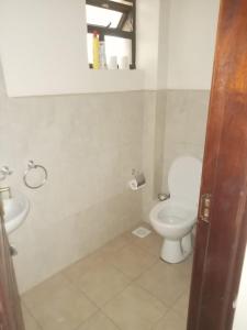 a bathroom with a toilet and a sink at Westpointe 2bedroom Luxury Apartment in Nairobi