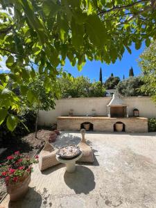 a garden with a fountain and a brick building at Verde Olive Three-Bedroom Holiday Home by Konnect in Kato Korakiana