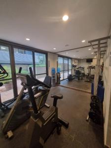 a gym with treadmills and ellipticals in a room at Flat Pancetti in Belo Horizonte