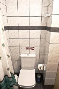 a small bathroom with a toilet and a sign on the wall at 302 Sea And Sun Apartment's in Kardamili +36 photos