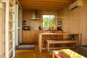 a kitchen and living room with a table and chairs at Chalet BLOK in Lac-Beauport