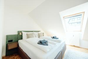 Postel nebo postele na pokoji v ubytování GH Luxury Apartments Graz, Gösser Haus