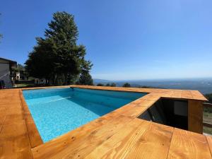a swimming pool on top of a wooden deck at Casa Pian di Farnè in Valdobbiadene