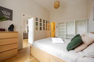 a bedroom with a bed with white sheets and pillows at Nancy Gare Centre Parking in Nancy