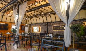 a dining room with tables and chairs in a building at City House Family Hotel & Restaurant in Ruse