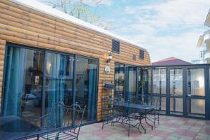 a building with glass doors and a table and chairs at City House Family Hotel & Restaurant in Ruse