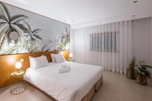 a bedroom with a large bed with a large painting on the wall at Villa Adaro - Large Luxury close to marina in Albufeira +56 photos