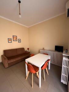 a living room with a table and a couch at Residence Rodi in Alassio